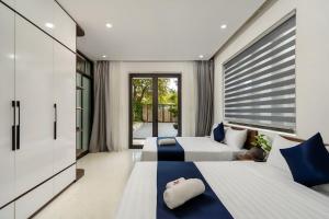 une chambre avec deux lits et une grande fenêtre dans l'établissement Coastal Heaven villa,5' walk beach, pacefull villa, à Hà Bàng