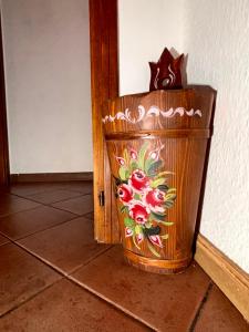 a wooden trash can sitting next to a wall at Casa Experience - Venas Di Cadore in Venas