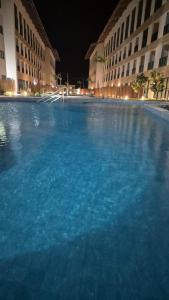 a large pool of blue water in front of buildings at Apartamento na Praia dos Carneiros a 250m do mar in Tamandaré