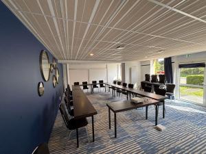 a conference room with tables and chairs and a large window at ibis Styles Morlaix in Morlaix +118 photos