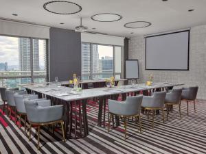 a large conference room with a long table and chairs at Novotel Suites Manila at Acqua in Manila +60 photos
