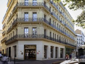 a large white building with a balcony on it at Mercure Marseille Canebière Vieux-Port in Marseille