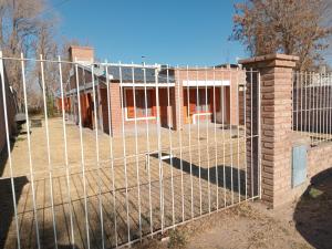 a metal fence in front of a house at La huella del cacique in Catriel