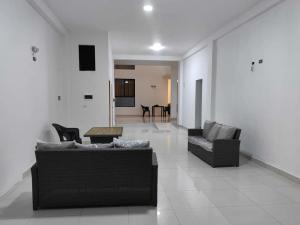 a living room with two couches and a table at Hotel Raymondi in Tarapoto