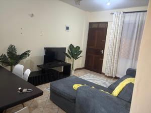 a living room with a couch and a table at Amtwapa 2bedroom apartment in Mtwapa