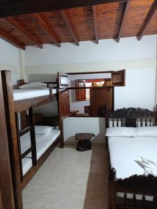 a room with a bunch of bunk beds at Colonial Hostal Filandia in El Pueblo