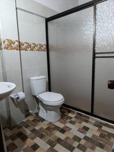 a bathroom with a toilet and a sink at Colonial Hostal Filandia in El Pueblo
