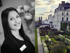 a woman is standing in front of a castle at Hotel Mercure Blois Centre in Blois