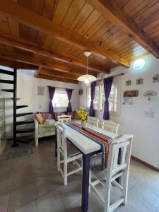 a living room with a table and chairs and a couch at Cabaña Paz in Capilla del Monte