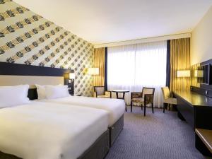 a hotel room with two beds and a desk at Mercure Antwerp City South in Antwerp +88 photos
