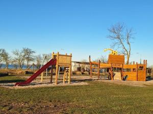 a park with a playground with a slide and a slideintend at Stranddistel links mit Sauna in Boiensdorf