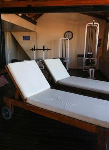 two beds in a room with a clock on the wall at Costa Bonita Aparts & Spa in Villa Carlos Paz