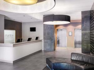 a lobby of a hotel with a reception desk at Mantra Hindmarsh Square in Adelaide
