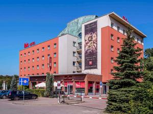 a building with a large sign on the side of it at Ibis Katowice - Zabrze in Zabrze