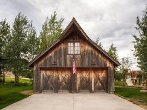 a barn with a flag in front of it at 104-Acre Private Ranch Retreat in Paradise Valley Montana in White City