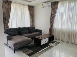 a living room with a couch and a coffee table at Luxury apartment in Madina