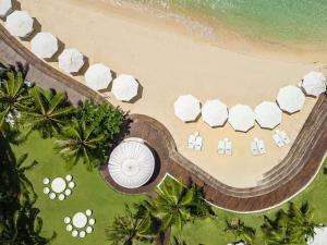 an overhead view of a beach with white umbrellas at Mövenpick Hotel Mactan Island Cebu in Mactan