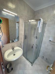 a bathroom with a shower and a sink at Albergaria 