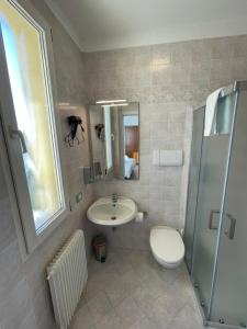 a bathroom with a sink and a toilet and a shower at Albergaria 