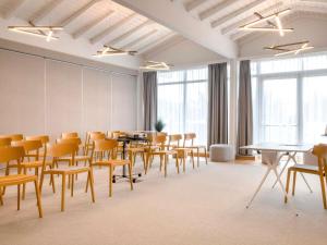 a room with tables and chairs and windows at Novotel Narbonne Sud A9/A61 in Narbonne +121 photos