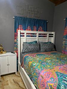 a bedroom with a large bed and blue curtains at Montego Bay, Ironshore Luxury Studio in Montego Bay +44 photos