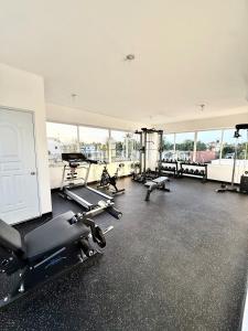a gym with several treadmills and exercise bikes in it at Alma Ivet III 5min From The Airport & Boca Chica Beach in Monte Adentro