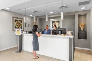a woman standing at a counter in a salon at Quest Campbelltown in Campbelltown