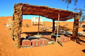 a shelter in the middle of the desert at Merzouga Hous in Merzouga