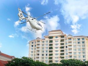 a helicopter is flying over a building at Sofitel Phnom Penh Phokeethra in Phnom Penh