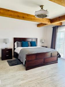 a bedroom with a large bed with blue pillows at Baja Beach House Beautiful House Plaza del Mar in Primo Tapia