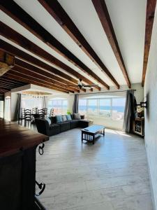 a living room with a couch and a table at Baja Beach House Beautiful House Plaza del Mar in Primo Tapia +57 photos