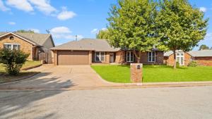 a brick house with a tree and a driveway at Luxury 3 Bdr Edmond, Fuseball, Pac-man, Sleeps 9 in Edmond