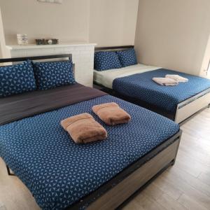 two beds with pillows on them in a room at THE BLOOR AC SUITE-Free Wifi-Train-Bus Stop Next Door in Toronto