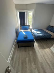 a small room with two beds and a window at THE BLOOR AC SUITE-Free Wifi-Train-Bus Stop Next Door in Toronto +5 photos