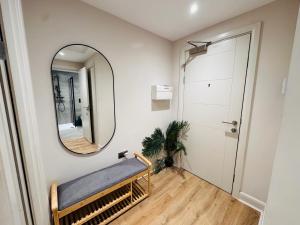 a dressing room with a mirror and a bench at Stylish Central Leeds Arena Apartment Free Parking in Leeds