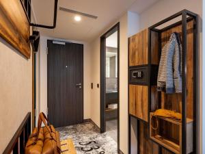 a hallway with a door leading to a bathroom at ibis Styles Hamburg Barmbek in Hamburg