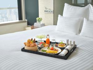a tray of food on top of a bed at Pullman Saigon Centre in Ho Chi Minh City