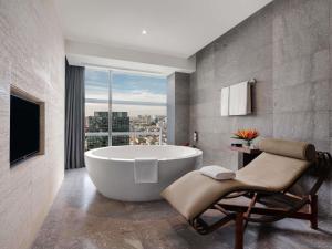 a bath tub in a bathroom with a window at Pullman Saigon Centre in Ho Chi Minh City +104 photos