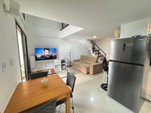 a kitchen and living room with a refrigerator and a table at Duplex no centro de Belém - Proximo a nova Doca in Belém