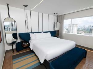 a bedroom with a large bed and a large window at Pullman Sao Paulo Vila Olimpia in Sao Paulo +283 photos