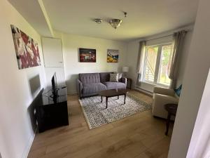 a living room with a couch and a table at City View Charm St John's 1br, 8min To Downtown in Port Rexton