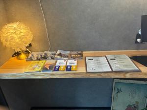 a wooden table with books and a lamp on it at Beppu 乃音 in Beppu +22 photos
