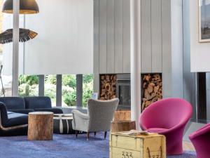 a living room with furniture and a fireplace at Peppers Gallery Hotel in Canberra