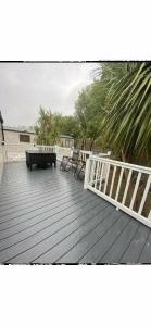 a deck with a bench and a table and chairs at Trecco Bay - Holiday Accommodation 18089 in Newton