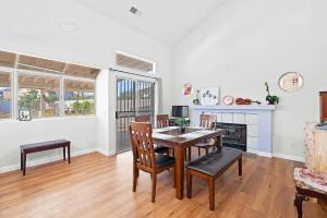 a dining room with a table and chairs and a fireplace at Bright Family Getaway w Garage&Prime SoCal Location in Valinda