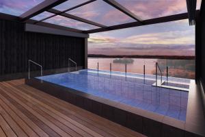 a swimming pool with a view of the water at Ooedo Onsen Monogatari Premium Shima Saichoraku in Shima