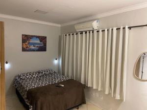 a bedroom with a bed next to a radiator at Apartamento 03 São Brás COP30 in Belém