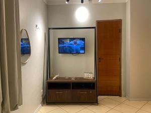 a bathroom with a sink and a tv on the wall at Apartamento 03 São Brás COP30 in Belém
