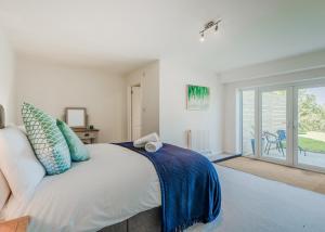 a bedroom with a bed and a sliding glass door at Romansleigh Retreat in Romansleigh