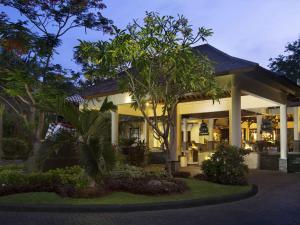 a home at night with trees and plants at Novotel Bali Nusa Dua in Nusa Dua